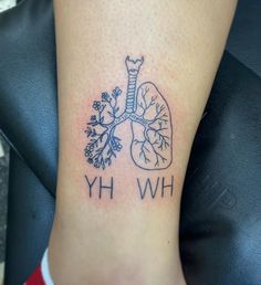 a small tattoo on the ankle that says hwhy with an lungs and flowers