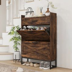 a wooden shoe cabinet sitting on top of a hard wood floor next to a stair case