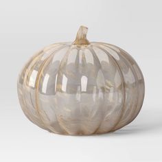 a glass pumpkin sitting on top of a white table