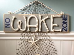 there is a sign that says no wake zone on the wall above a basket with seashells