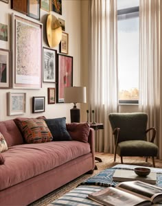 a living room filled with furniture and pictures on the wall