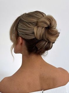 a woman with blonde hair in a low bun