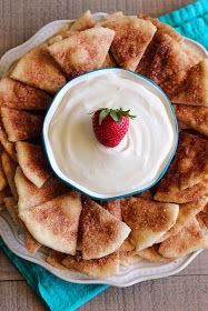 a plate topped with pita chips covered in cream and a strawberries on top