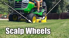 a man riding on the back of a green lawn mower