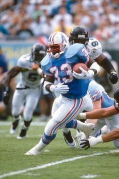 a football player running with the ball during a game