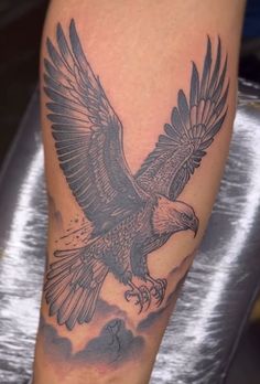 an eagle tattoo is shown on the leg