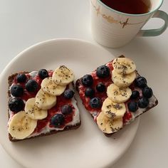 two pieces of toast with fruit and yogurt on them next to a cup of tea