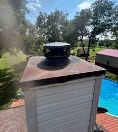 a hot tub sitting on top of a roof next to a swimming pool in a backyard