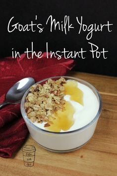 a bowl filled with granola and yogurt on top of a wooden cutting board