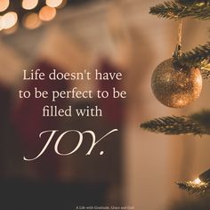 a christmas ornament hanging from a tree with the words, life doesn't have to be perfect to be filled with joy