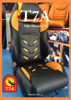 a black and orange chair with the words tta on it's back side