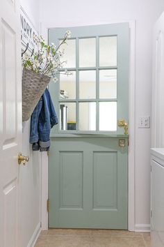 a green door with a basket hanging on it