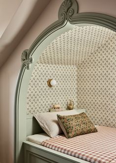 a bedroom with a bed, nightstand and wall papered walls in an arched niche