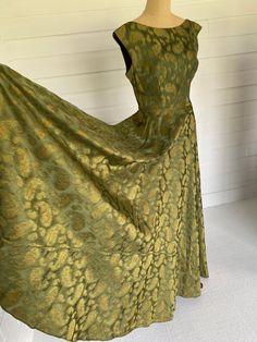 Beautiful quality, elegant, woven silk brocade with abstracted ancient floral Persian 'Gul' motif. Bias cut, high front neckline with straight waist, extended shoulder sleeve cut, V shape back neckline and V shape back pleated waist. Brass side zip. Absolutely stunning on, fabric has a small number of pin size holes un noticeable whilst on, price reflects this. Would be a perfect piece to alter to your own sizing. Current size would fit a 10 - 12 and see measurements listed. Please see individua Green Brocade Formal Dress, Formal Green Brocade Dress, Green Brocade Dress For Formal Occasions, Gold Fitted Jacquard Dress, Fitted Gold Jacquard Dress, Fitted Brocade Dresses, Vintage Brocade Fitted Dress, Fitted Vintage Brocade Dress, Elegant Formal Dress With Vintage Pattern