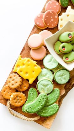 a wooden board topped with lots of different types of cookies