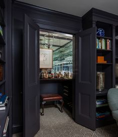 an open door leading into a room with bookshelves and shelves on both sides