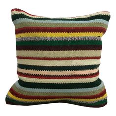 a multicolored striped pillow on a white background