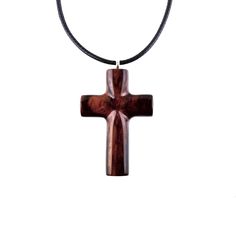 "Hand carved in Cocobolo, an exotic hardwood that originates from Mexico, this reversible wooden cross pendant is one of a kind. This particular exotic wood tends to darken over time, therefore by the time you will receive this pendant the wood might have settled into darker reddish-brown tones. The pendant is sealed with multiple layers of glossy wood lacquer that add a lot of shine to the piece. - This pendant measures approximately 1.5\" tall by 1\" wide (3.3cm by 2.5cm). - The pendant comes with an adjustable 18-20\" (47-51cm) black Korea waxed cord with lobster clasp, ready to wear. The waxed cord has a shinny snakeskin like texture and is a great non-fraying alternative to leather. For more hand carved WOOD CROSS PENDANTS please visit our entire section within the shop here: http://w Woodcarving Ideas, Raven Necklace, Necklace Christian, Wood Cross, Wood Crosses, Wooden Cross, Christian Jewelry, Brown Tones, Reddish Brown