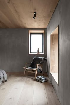 a chair sitting in front of a window on top of a hard wood floor