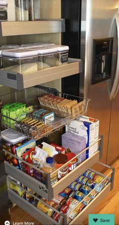 an organized kitchen drawer in front of a stainless steel refrigerator with food and drinks on it