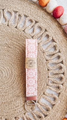 a pink keychain sitting on top of a rug