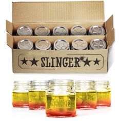 six jars filled with different colored liquid in front of a cardboard box that says slinger