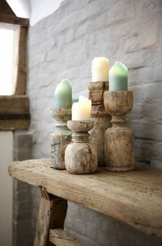 some candles are sitting on a wooden table