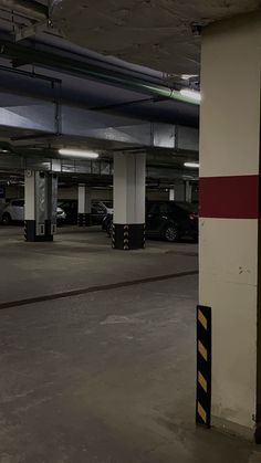 an empty parking garage with cars parked in the space next to each other on either side