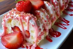 strawberry shortcakes with icing and strawberries on a white plate, ready to be eaten