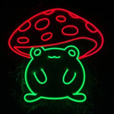 a lit up mushroom sitting on top of a green toad with red dots and black background