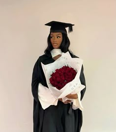 a doll dressed as a graduate holding flowers and a bouquet of red roses with the words i love you written on it