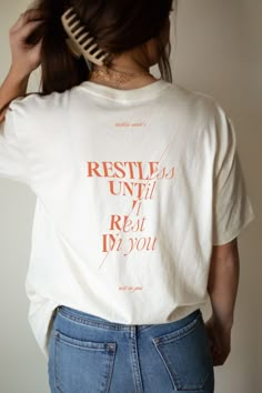 Introducing our "Restless Until I Rest in You" Christian Shirt - a garment designed to inspire and uplift, combining comfort with a powerful message of faith. Crafted from the softest materials, this shirt is not just a piece of clothing; it's a statement of your unwavering trust. This tee serves as a constant reminder of the profound peace that comes from surrendering. Whether you're heading to worship, spending time in quiet reflection, or simply going about your day, this shirt is a tangible Fun T Shirt Ideas, Christian Shirts Designs Aesthetic, Conference Tshirt Design, Cool Christian Shirts, Christian Graphic Tees Design, Tshirt Merch Design, Church Merch Ideas, Church Tshirt Designs, Christian Tshirt Designs