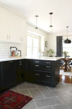 a kitchen with black cabinets and white counter tops is pictured in this image from the front view