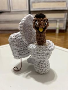 a crocheted stuffed animal sitting on top of a table