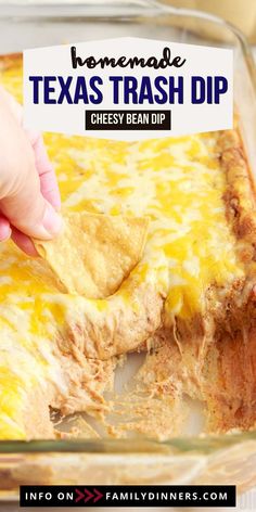 a hand dipping a tortilla chip into a casserole dish