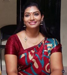 a woman in a red and blue sari