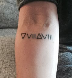 a person with a tattoo on their arm that reads viviii and has the word viviii written in cursive font