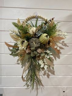 a bouquet of flowers is hanging on the wall