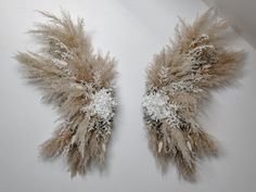 two pieces of art made out of feathers