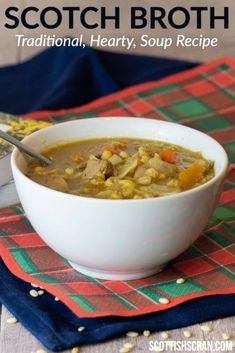 a white bowl filled with soup sitting on top of a red and green table cloth