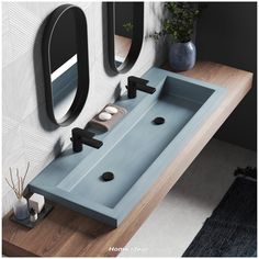 a bathroom sink with two mirrors above it