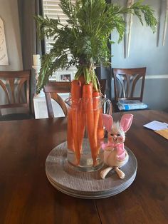 there are carrots that have been placed in the vase on the dining room table