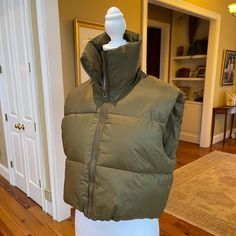 Nwt- Never Worn! Womens Cropped Puffer Vest, High Stand Collar, Front Full Zip, Adjustable Drawstring Hem, Cropped Length, Solid Color, Fashion Sleeveless, Lightweight Warm Puffer Gilet. Army Green Sz M Measurements: Length - 18.5 Inches From Top Of Shoulder To Bottom Hemline 20 Inches From Armpit To Armpit Winter Khaki Vest, Sleeveless Puffer Vest For Cold Weather, Khaki Sleeveless Winter Vest, Green Cropped Puffer Vest Outfit, Cotton Puffer Vest, Sleeveless Cotton Puffer Outerwear, Green Puffy Jacket, Solid Puffer Sleeveless Vest, Functional Green Puffer Jacket