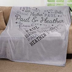 a couch covered in a personalized blanket