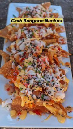 some nachos are on a white plate with black and yellow sprinkles