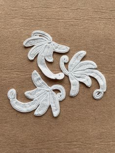 two white appliques sitting on top of a cardboard box