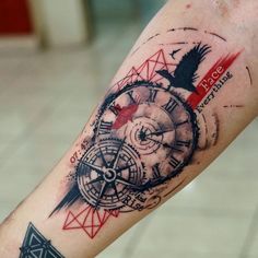 a man with a compass tattoo on his arm