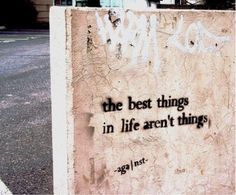 graffiti on the side of a building that says, the best things in life aren't things