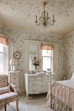 a bedroom with floral wallpaper and white furniture