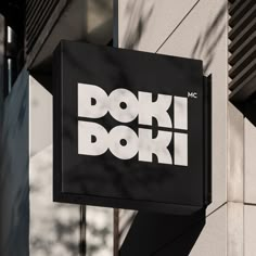 a doki doki sign hanging from the side of a building